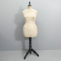 A Stockman's dressmaker's mannequin on ebonised tripod stand. Height 161cm.