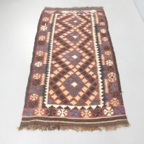 A brown-ground Kazak rug. 186x100cm.