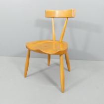A mid-century blonde wood Brutalist side chair with sculpted seat.