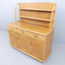 A mid-century light oak dresser, with open plate rack, and three drawers above one single and one