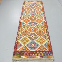 A Chobi Kilim runner. 236x80cm.