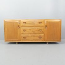 ERCOL - A model 455 Windsor sideboard, with three drawers between two cupboards and maker's mark.