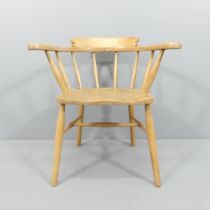 A mid-century light elm bow-arm Captain's chair.