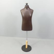 A modern leather covered mannequin on stand, of small male form. Height overall 130cm.