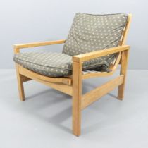 A mid-century teak and bent-ply framed and upholstered lounge chair, with label beneath for "