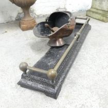 A cast iron fire surround, 120x16x29cm, and a copper coal scuttle with shovel. (2)