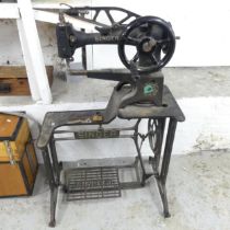 A Singer treadle sewing machine on metal base. Overall 76x112x36cm.