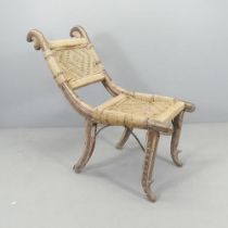 An African hardwood tribal chair, with woven seat and back panels and metal mounts. Overall