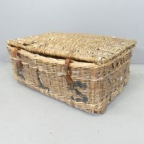 A wicker laundry basked, marked ALS. 75x31x51cm. A/F Damage to lid and general areas of loss.