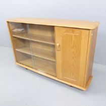 A mid-century elm bookcase / display cabinet, with one cupboard door and two sliding glass doors