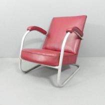 A mid-century modernist cantilever tubular steel lounge chair.