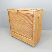 A vintage pine tambour fronted filing cabinet. 88x42x90cm Tambour front opens and closes easily, but