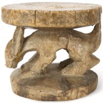 An antique West African hardwood stool with carved Aardvark figure, height 24cm Some repairs to