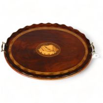 A Georgian mahogany tray with inlay boxwood conch shell motif and brass handles, length 69cm Two