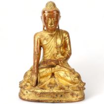 A Burmese 19th century gilt-bronze seated Buddha, height 42cm