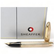 A Sheaffer Legacy Heritage hallmarked sterling silver fountain pen, with 18ct gold nib and