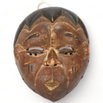 A small Ibibio, Nigeria carved wood mask, height 17cm