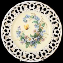 A 19th century porcelain cabinet plate, with hand painted butterfly and flowers in pierced gilded