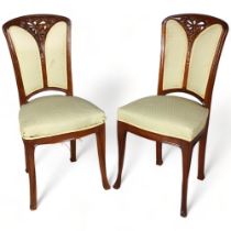 A pair of French Art Nouveau walnut salon chairs, in the manner of Louis Majorelle, with relief