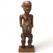 An 19th century Congo wood carved female figure, height 65cm On modern wooden plinth, damage to