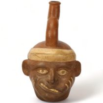 A Pre-Columbian stirrup portrait vessel, museum/shop label to base dated 1935, height 23cm Good