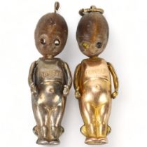 Two First World War period "Fumsup" good luck charms, silver and gold plated, with moving arms,