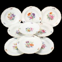 A set of Meissen porcelain plates with painted floral centres and gilded edges (9)
