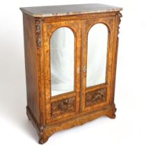 A 19th century walnut pier cabinet, red marble top and bevelled mirror doors with carved hounds