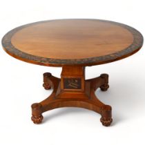 A Late Victorian mahogany centre table, with veneer fringe and panels on stem decorated with fruit