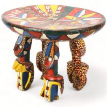 A Bozo, Mali wood carved and painted stool, with male and female figure supports, height 30cm,