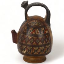 A 16th century Peruvian terracotta ceremonial chicha pot, with puma handle and geometric painted