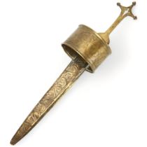An African Tuareg arm dagger, steel baled with chased brass sheath and mounts and cruciform