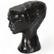 A mid 20th century stylised ceramic bust of a woman, black glaze, signed to base Nairn Pottery?