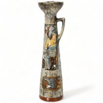 A mid-century Italian Brutalist ceramic candle holder, with painted enamel figures on matt glaze,
