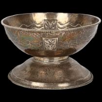 An Arts and Crafts white metal pedestal bowl, allover planished decoration with relief embossed