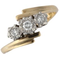 An 18ct gold three stone diamond crossover ring, platinum illusion set with modern round brilliant-