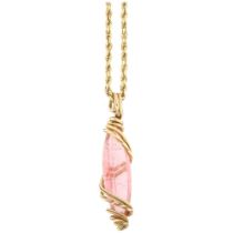 A Continental pink tourmaline pendant necklace, the long marquise-cut tourmaline within wirework