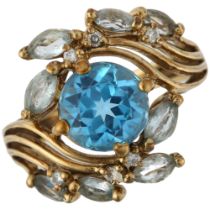 A modern 9ct gold blue topaz and diamond floral crossover ring, setting height 16.7mm, size K, 4g No