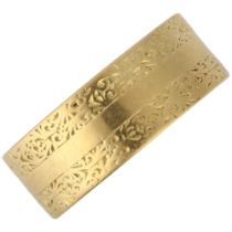 A mid-20th century 18ct gold wedding band ring, maker WW Ltd, London 1956, engraved foliate
