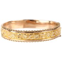 An early 20th century 9ct rose gold hinged bangle, maker A Brothers, Birmingham 1911, relief