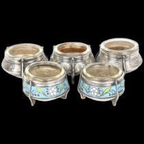 A group of 5 Russian white metal and enamel table salt cellars, with blue glass liners, marked