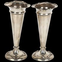 A pair of Edwardian silver bud vases, A&J Zimmerman, Birmingham 1908, 13.5cm, loaded bases Both have