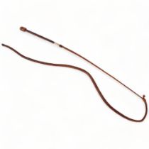 An Antique leather riding whip, with an engraved 15ct gold band