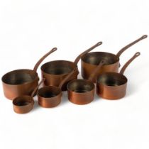 A graduated set of 7 Vintage French copper saucepans, with cast-iron handles, largest 20cm diameter