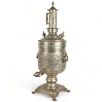 A large engraved and embossed brass samovar, on plinth with lion paw feet, H82cm