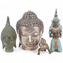 A verdigris bronze Buddha's head, 15cm, a silver plated Buddha's head, and 2 other figures