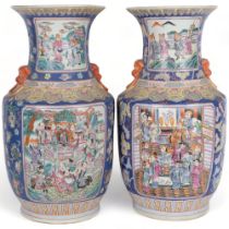 A pair of Oriental blue ground vases, with figure decorated enamelled panels, H46cm