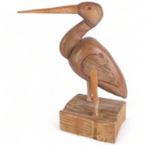 A carved and painted wood study of a pelican on stand, H40cm