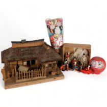 A handmade Japanese wooden building, figures, dolls, etc, and a glazed cabinet containing various