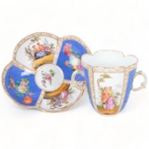 An Antique Dresden quatrefoil 2-handled cup and saucer, painted blue and white panels decorated with